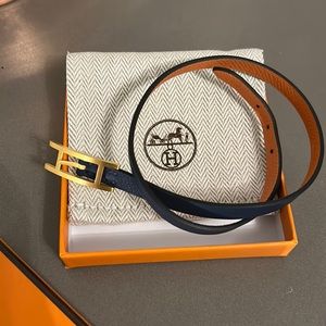 Hermes leather bracelet, orange and navy with brushed gold clasp. Like new